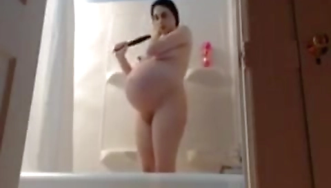 pregnant latina huge belly in te bathroom